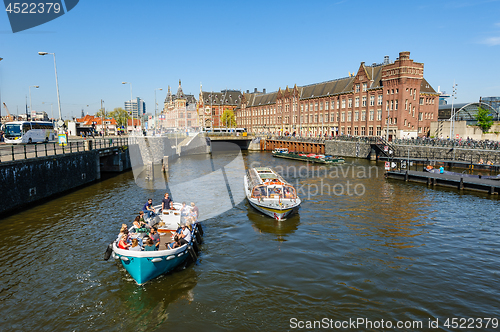 Image of Sightseeng at Canal Boats near the Central Station of Amsterdam