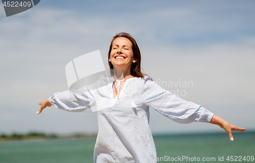 Image of happy smiling woman on summer beach