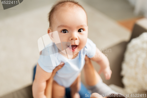 Image of close up of asian baby boy with mother