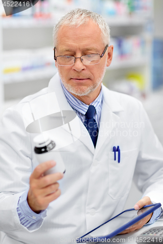 Image of senior with tablet pc at pharmacy