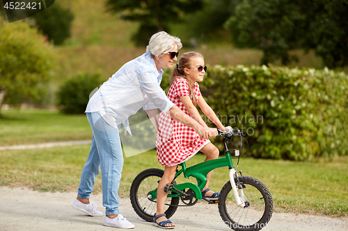 Image of grandmother and granddaughter with bicycles