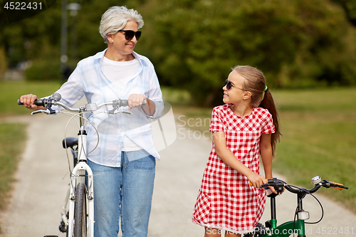 Image of grandmother and granddaughter with bicycles