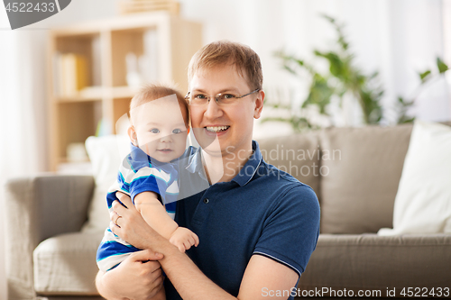 Image of happy baby boy with father at home