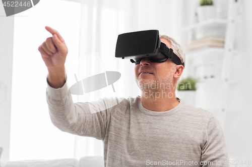 Image of old man in virtual reality headset or 3d glasses