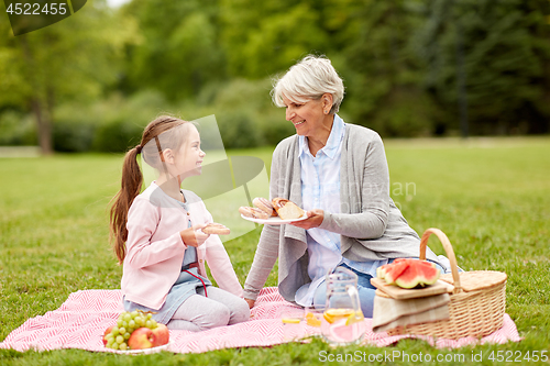 Image of grandmother and granddaughter at picnic in park