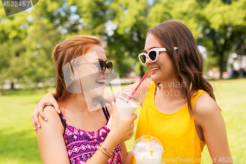 Image of teenage girls with milk shakes at summer park