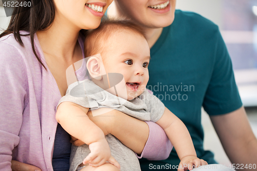 Image of happy family with baby boy at home