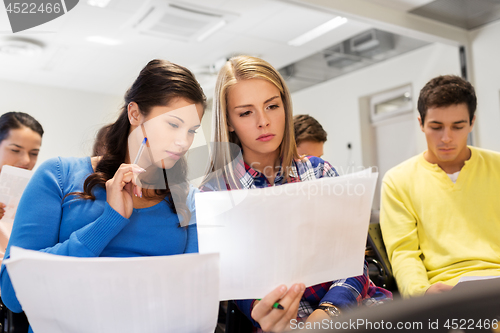 Image of student girls with tests at lecture hall