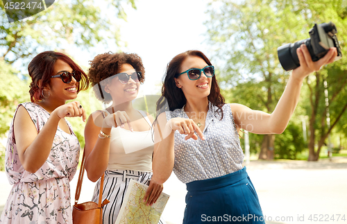 Image of women with map travelling and recording video blog