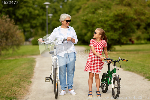 Image of grandmother and granddaughter with bicycles