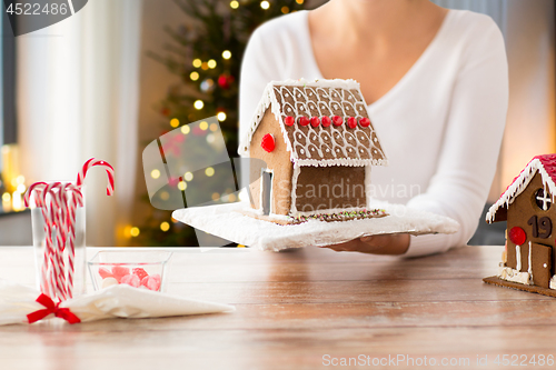 Image of close up of woman with christmas gingerbread house
