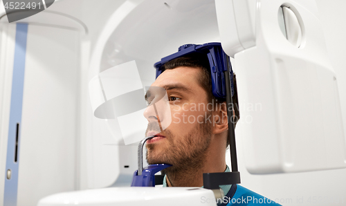 Image of patient having x-ray scanning at dental clinic