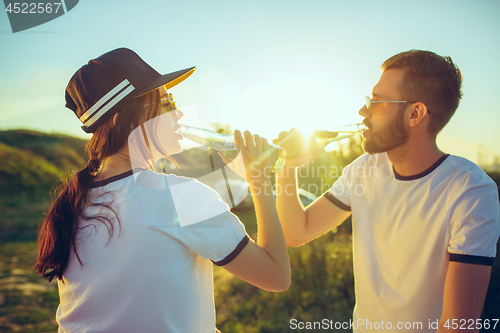 Image of Couple resting on the beach on a summer day near river