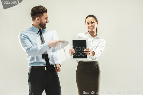 Image of Happy boss. Man and his secretary standing at office