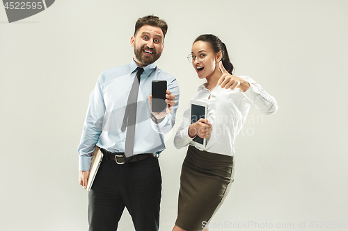 Image of a business man shows the laptop to his colleague in the office.