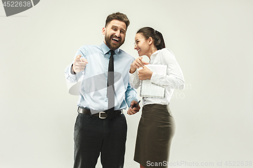 Image of Happy boss. Man and his secretary standing at office