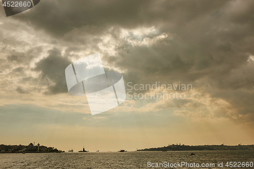 Image of The rays of the sun breaking through clouds over the sea