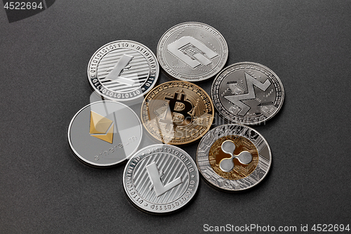 Image of Coins of crypto currency are presented on a dark background. Virtual money concept.