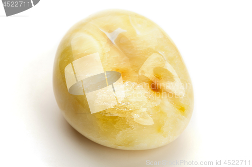 Image of Natural amber. A piece of yellow opaque natural amber on white background.