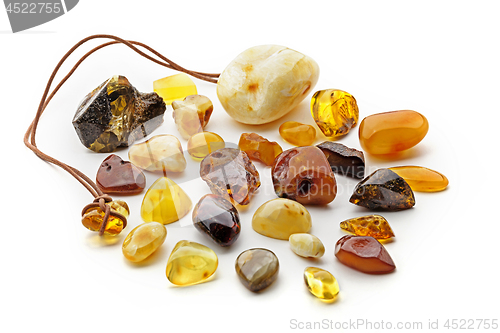 Image of Natural amber. Many pieces of different colors of natural amber on white background.