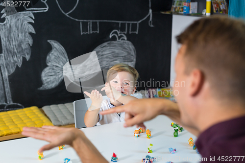 Image of Cute little toddler boy at speechtherapist session.