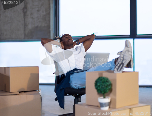 Image of young black male architect taking a break on construction site