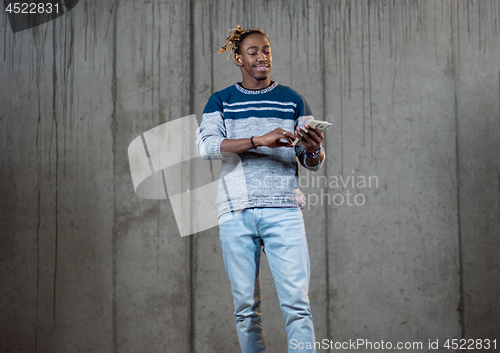 Image of black business man displaying a spread of american dollar cash m