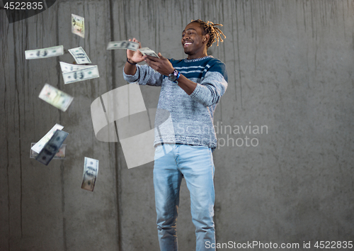 Image of black businessman making the rain of money