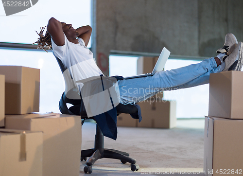 Image of young black male architect taking a break on construction site