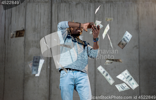 Image of black businessman making the rain of money