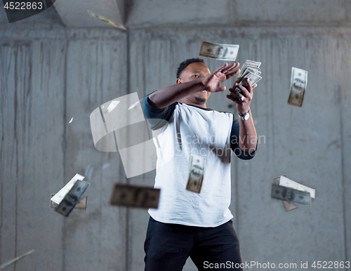 Image of black businessman making the rain of money