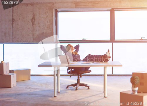 Image of young female architect taking a break on construction site