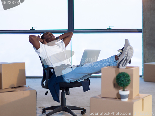 Image of young black male architect taking a break on construction site