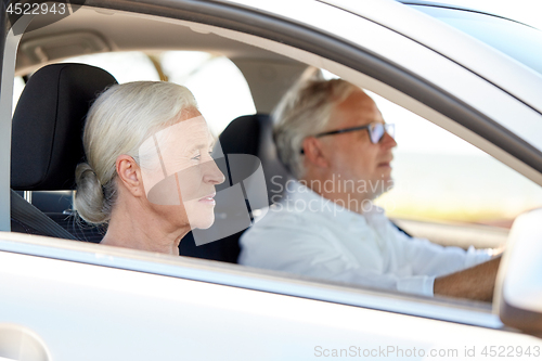 Image of happy senior couple driving in car