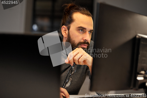 Image of close up of creative man working at night office