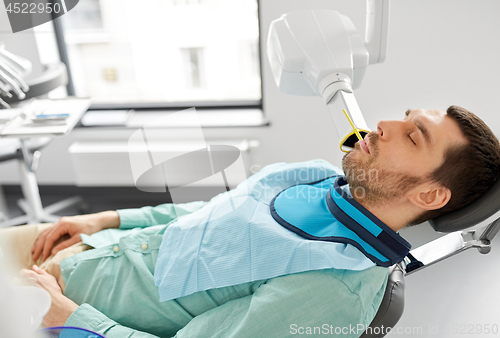 Image of patient having x-ray scanning at dental clinic