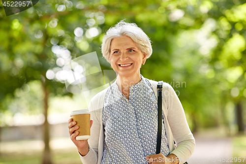 Image of senior woman drinking takeaway coffee at park