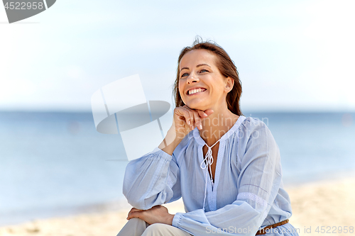 Image of happy smiling woman on summer beach