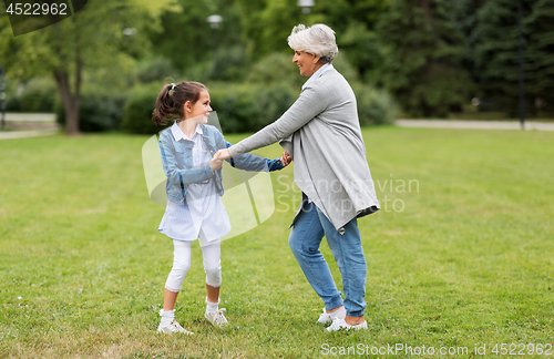 Image of grandmother and granddaughter playing at park