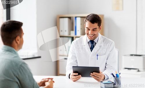 Image of doctor with tablet computer and patient at clinic