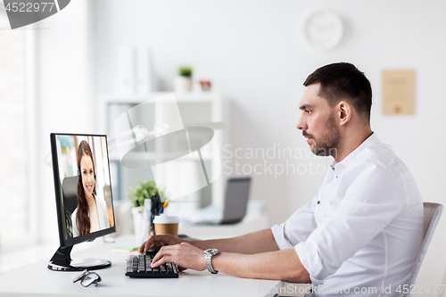 Image of businessman having video call on pc at office