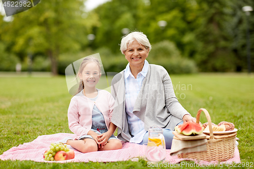 Image of grandmother and granddaughter at picnic in park