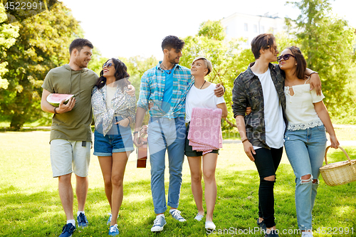 Image of friends with guitar going to picnic at park