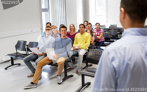 Image of group of students and teacher at lecture hall