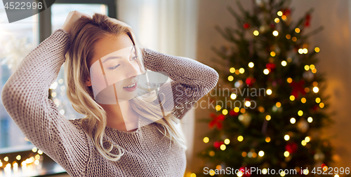 Image of happy young woman or teenage girl at home