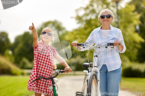 Image of grandmother and granddaughter with bicycles
