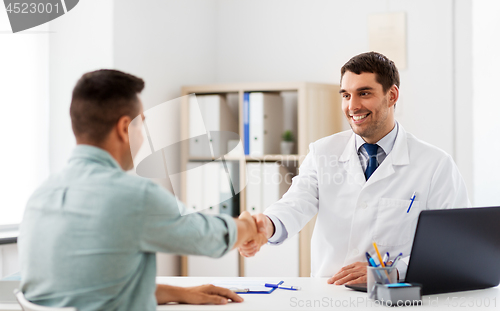 Image of doctor and male patient shaking hands at hospital