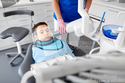 Image of dentist making x-ray of kid teeth at dental clinic