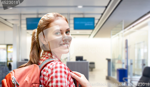 Image of young woman with backpack over airport terminal