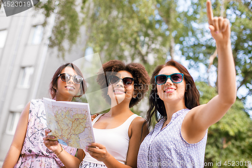 Image of happy women with map on street in summer city